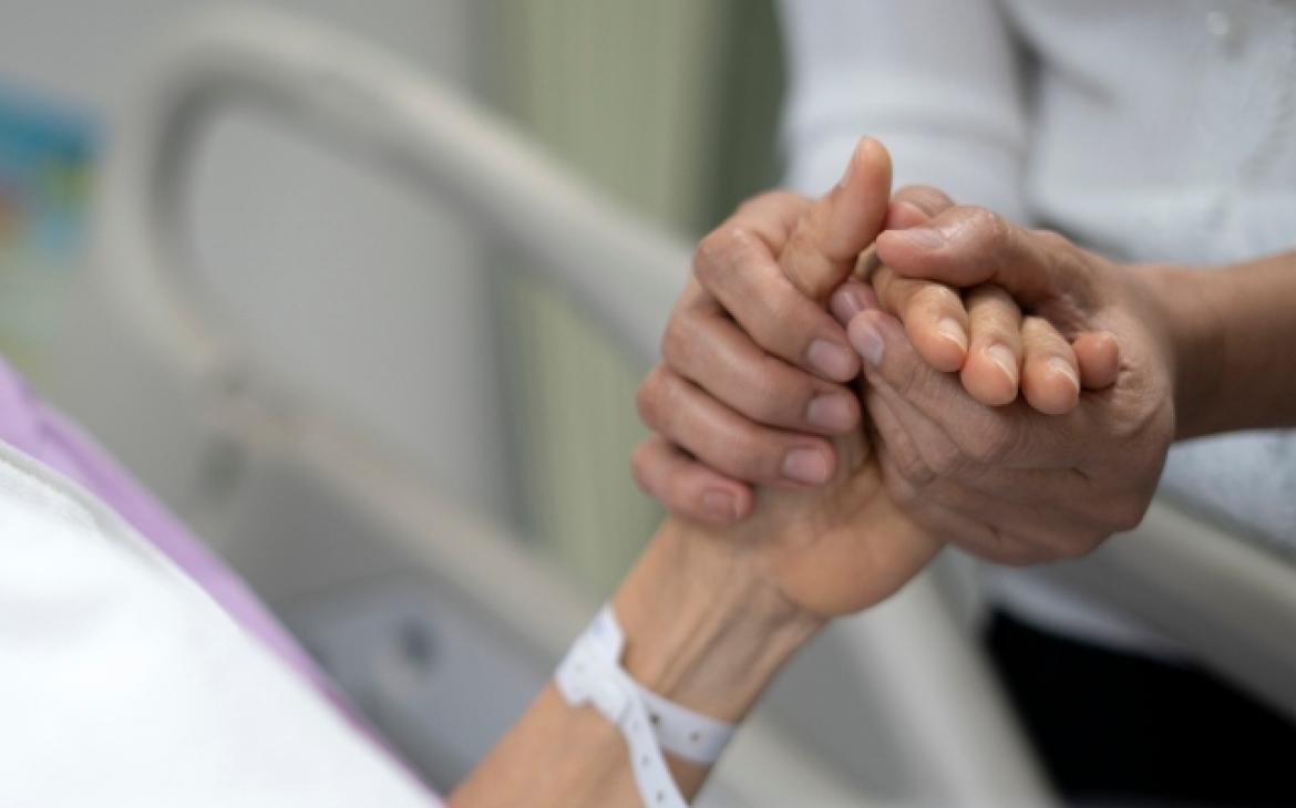 cancer patient holding hands